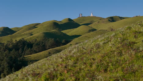 serene rolling hills with buddha statue and camping tent