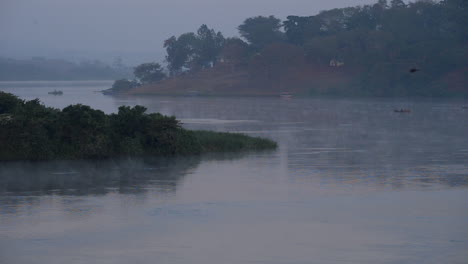 a boat shuttles visitors from islands on the nile river in jinja, uganda