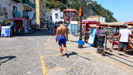 man walking through marina grande, sorrento