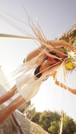 woman with braids near palm trees in summer