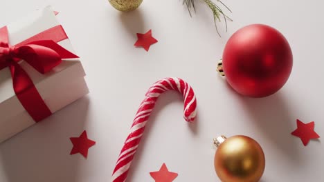 video of two christmas canes and decorations over white background