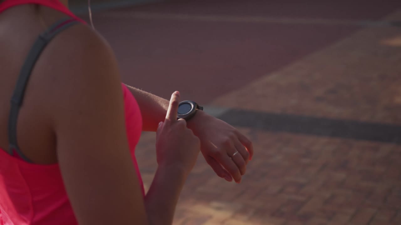 Woman looking at her watch in a park