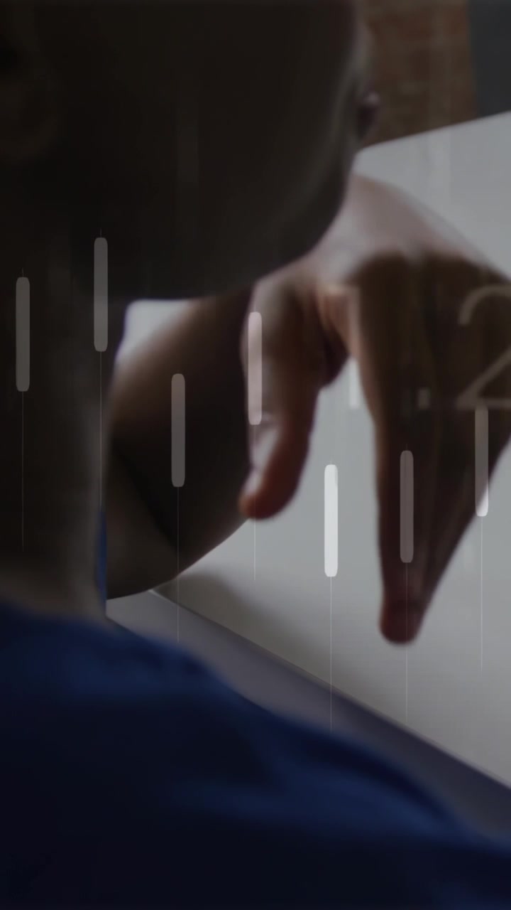 Vertical video: Woman lifting hand extending arm over white table, line graph animating for finance