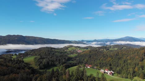 rural small town residential houses in lush green low mist mountain valley aerial fly over