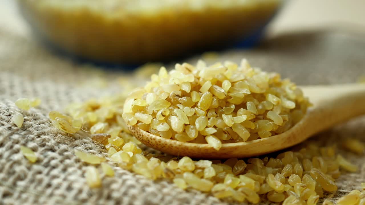 Bulgur wheat in a wooden spoon