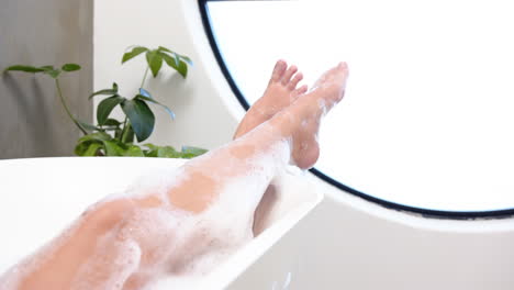 relaxing in bathtub, young woman enjoying spa day with bubbles