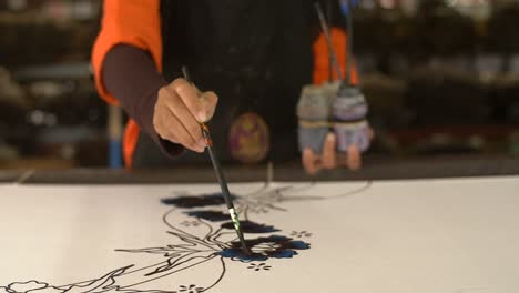 malaysian woman painting a batik 1