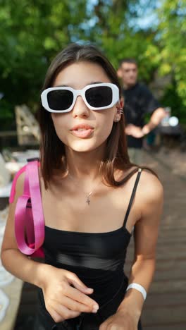 young woman wearing sunglasses at outdoor event