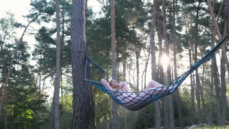 young woman relaxing on a mattress in summer forest young woman relaxing on a mattress in summer forest girl meditates in the lotus position in the forest