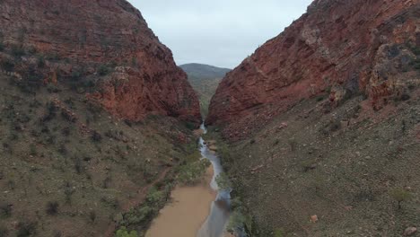 dramatic view of simpsons gap with creek in larapinta trail near alice springs