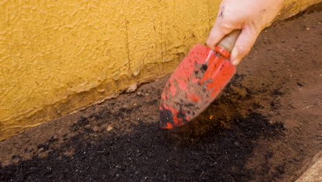 putting fertilizer in a small garden at home