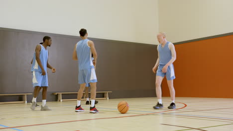 practicing dribbling and teamwork, basketball players in gymnasium honing skills