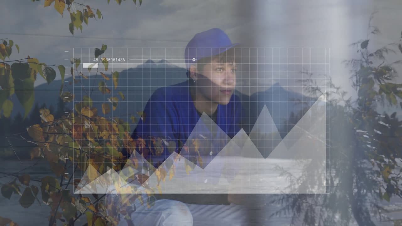 Young person looking out window with graph animation over autumn landscape