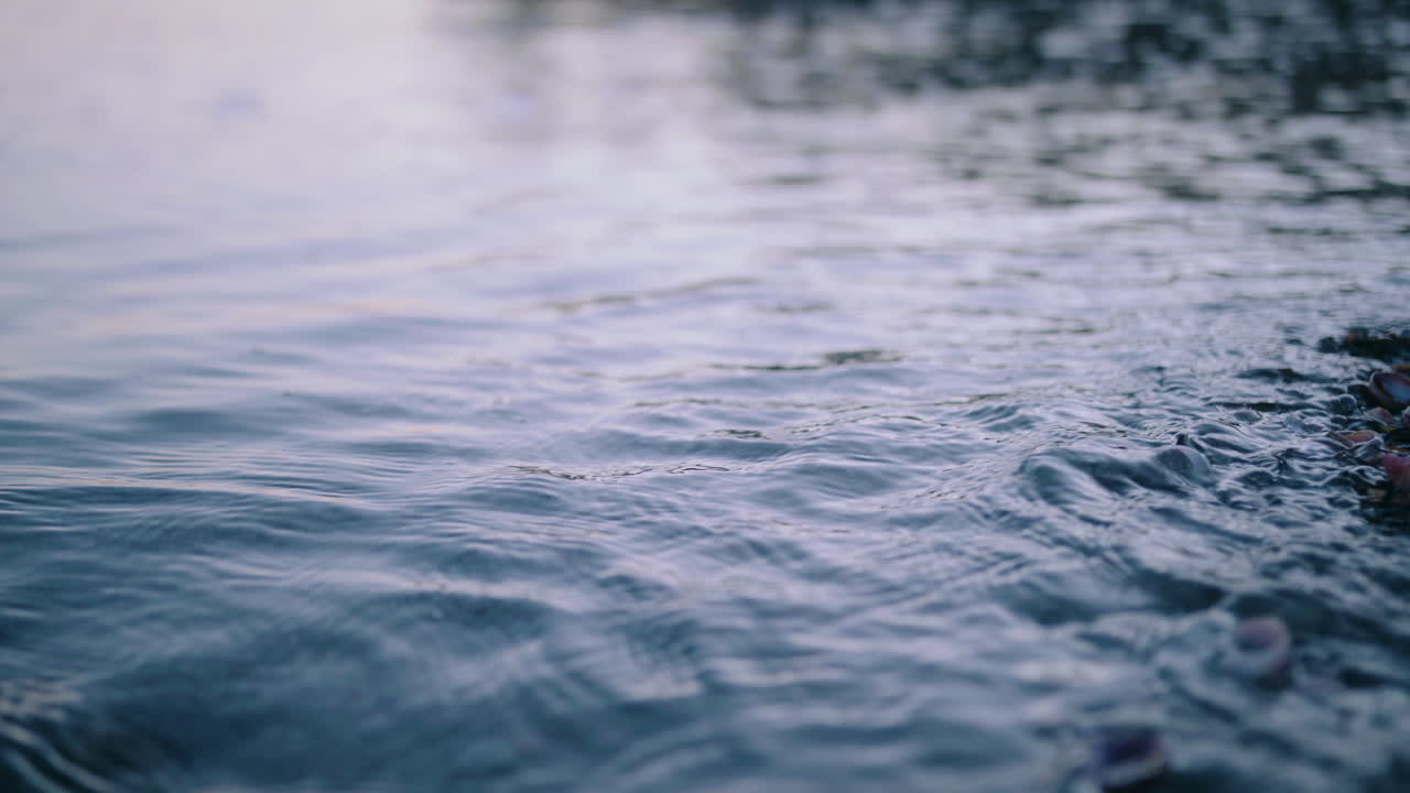 Waves shore ocean water over pebble stone beach slow gentle nature outdoor relaxing
