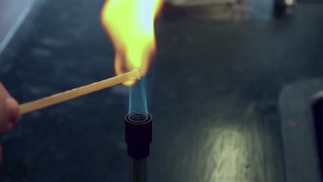 close up of blue bunsen burner flame followed by sodium flame test burning yellow