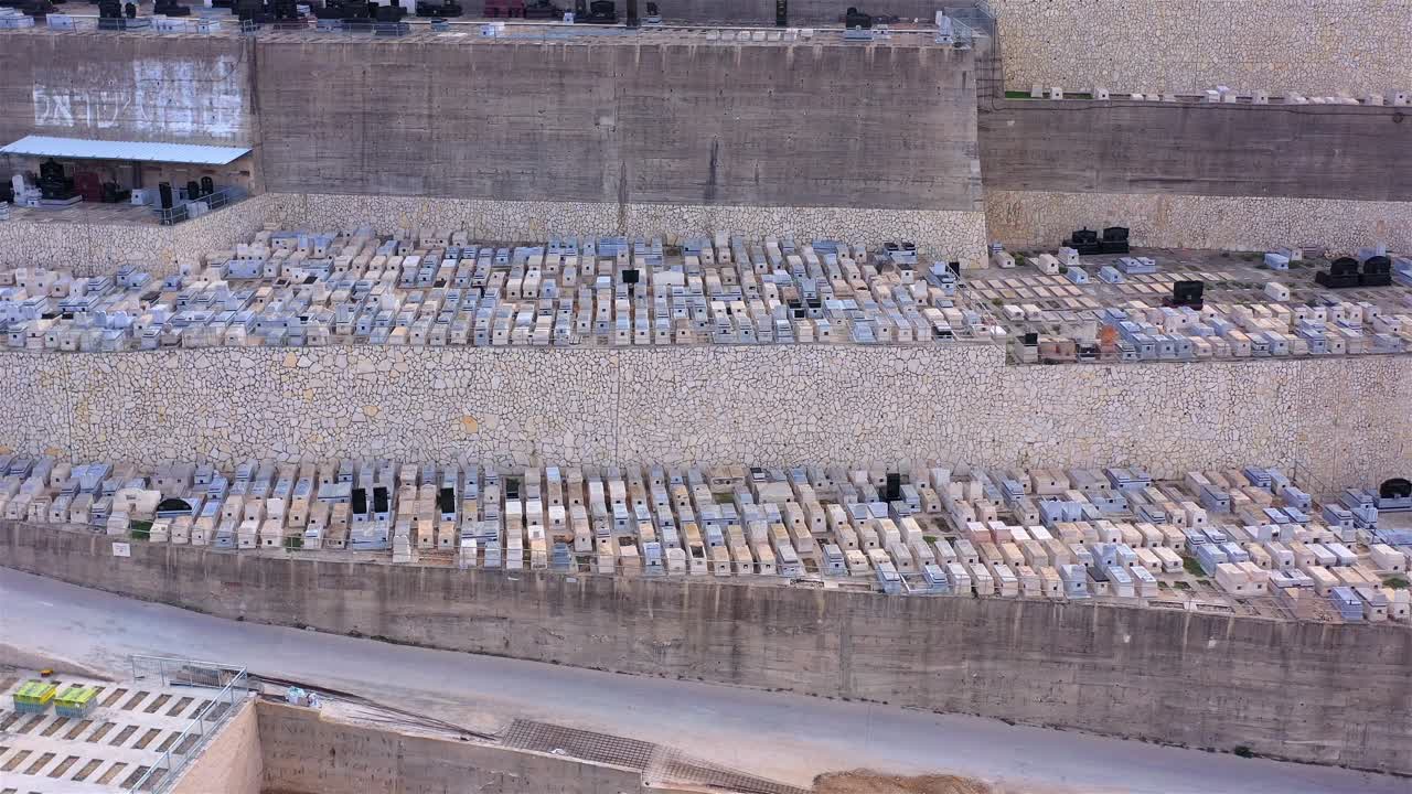 Aerial view of a large terraced hillside cemetery