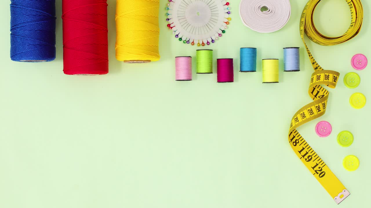 Sewing items move on top of green theme Stop motion
