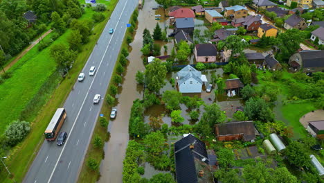 flooded residential area near main road, houses and backyard, natural disaster