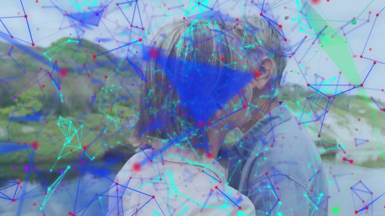 Digital overlay appearing while woman turning toward man and sharing warm smiles, hugging lakeside