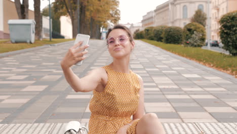 woman taking selfie in city park