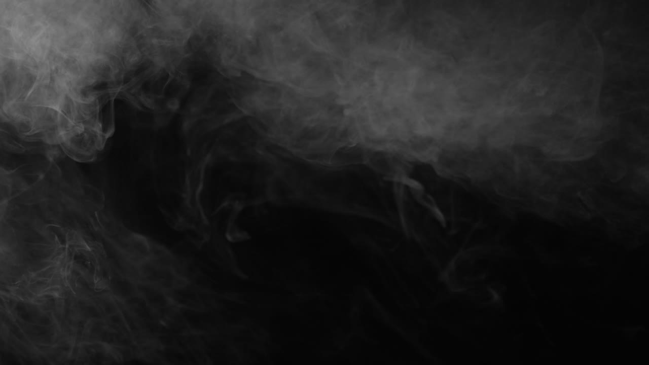 Slowly moving, swirling smoke creates dark, mysterious texture on black screen. Atmospheric background element for cinematic use
