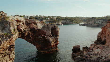 a view of the natural arch of es pontas near cala llombards in majorca, balearic islands, spain