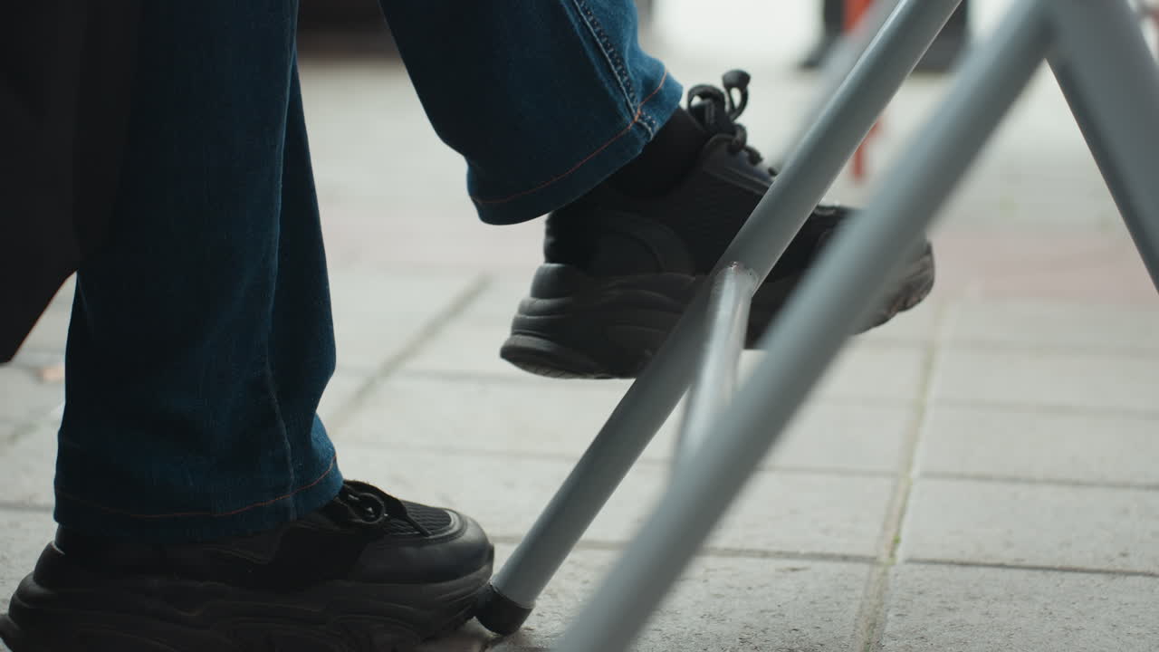 Feet tap on urban pavement. Casual city atmosphere featuring melodic foot tapping on tiled streets. Lively urban environment where feet rhythmically strike pavement in relaxed manner