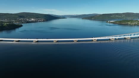 Panoramic-aerial-of-Nordhordland-Bridge,-approaching-to-end-in-a-birdseye-view-above-lanes