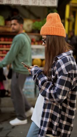 young woman using phone in city