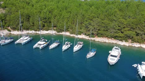 aerial view small group of boats anchored at harbor on the coast of fiskardo