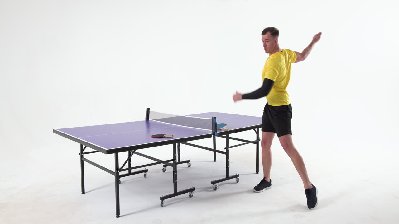 Male table tennis player warming up before game of table tennis on white background, copy space