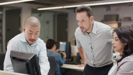 Woman-manager-leading-diverse-team-meeting-in-small-business.-Three-people-working-around-computer-late-at-night