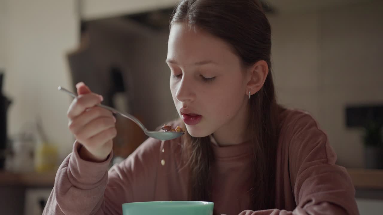 Girl eating breakfast at table