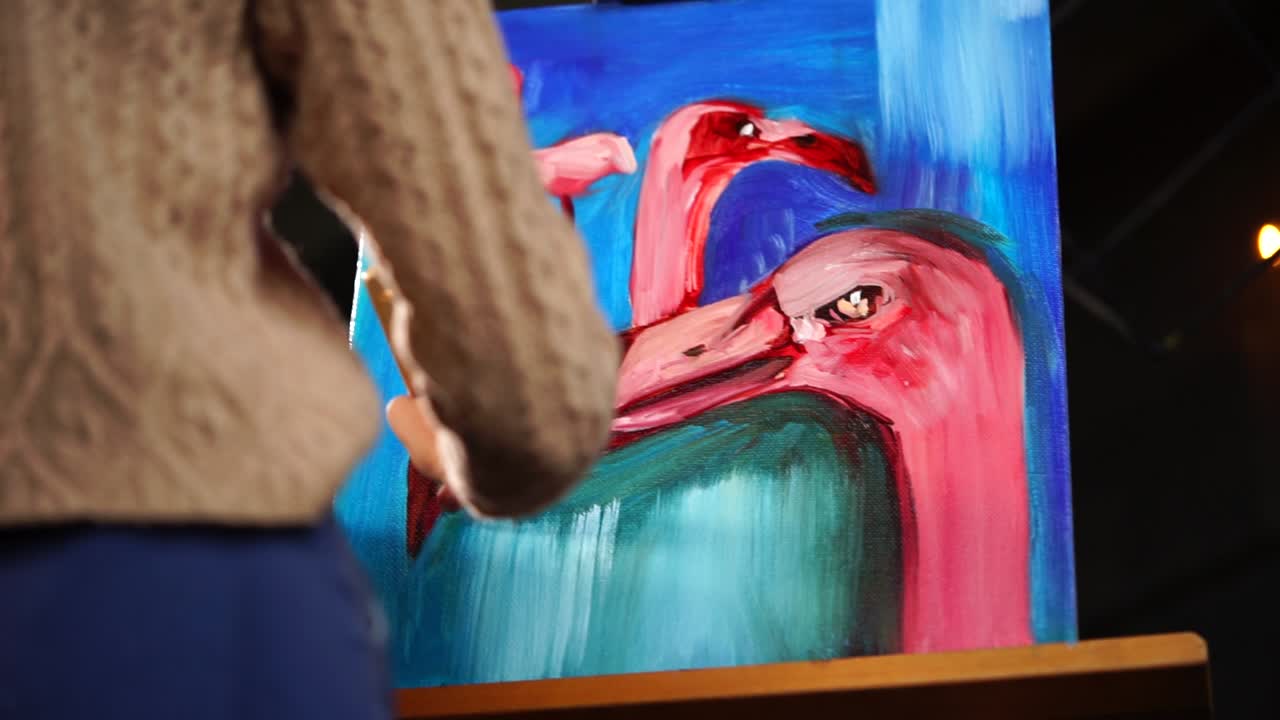 Woman painting flamingos