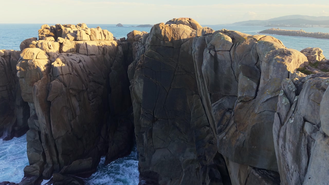Waves Crashing Against The Cantis De Papel (Paper Cliffs) In Lugo, Galicia, Spain. - aerial shot