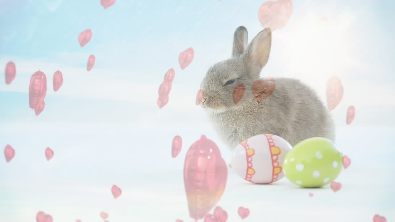 小さなピンクのハートとイースターエッグがあるうさぎのアニメーション
