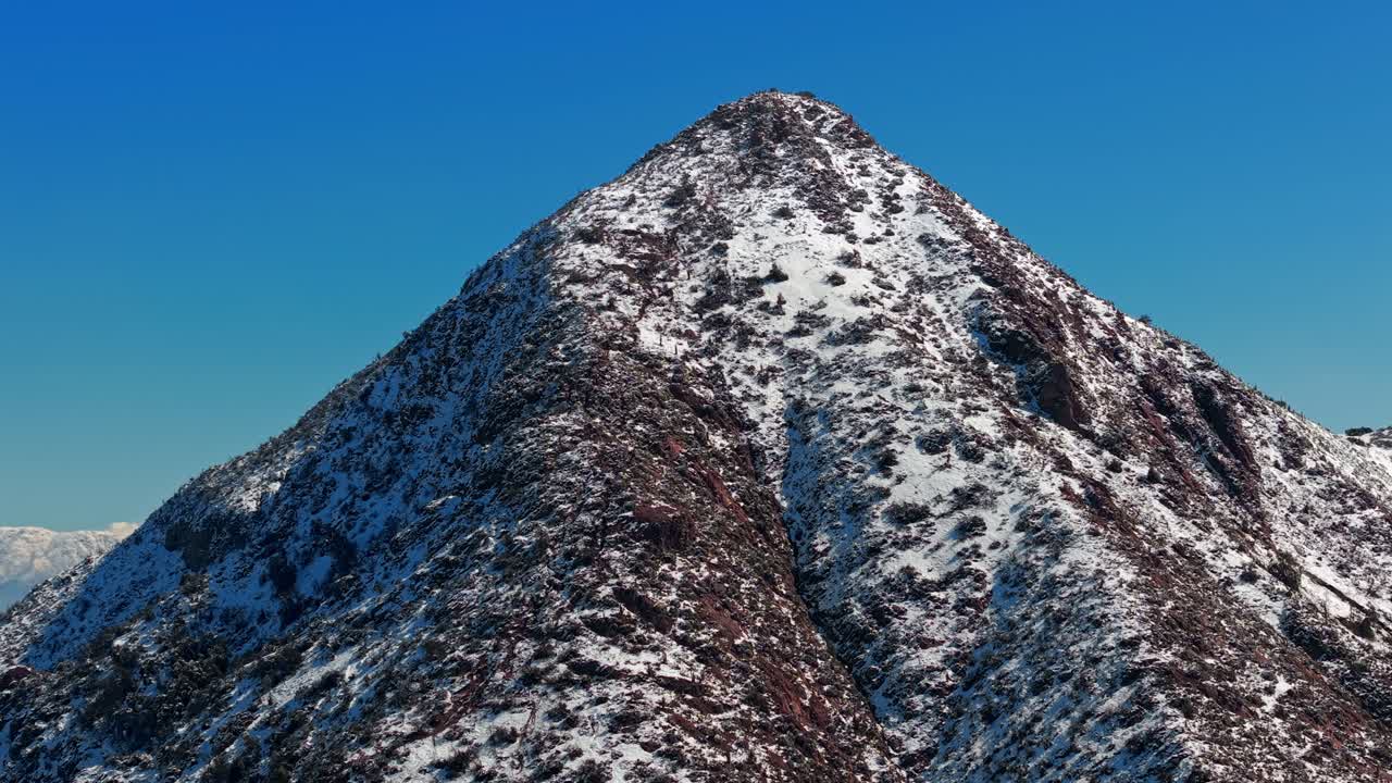 Aerial Landscape of Snowy Top Mountain Summit, Blue Skyline background, in Santiago de Chile Andean Cordillera, Manquehue Hill