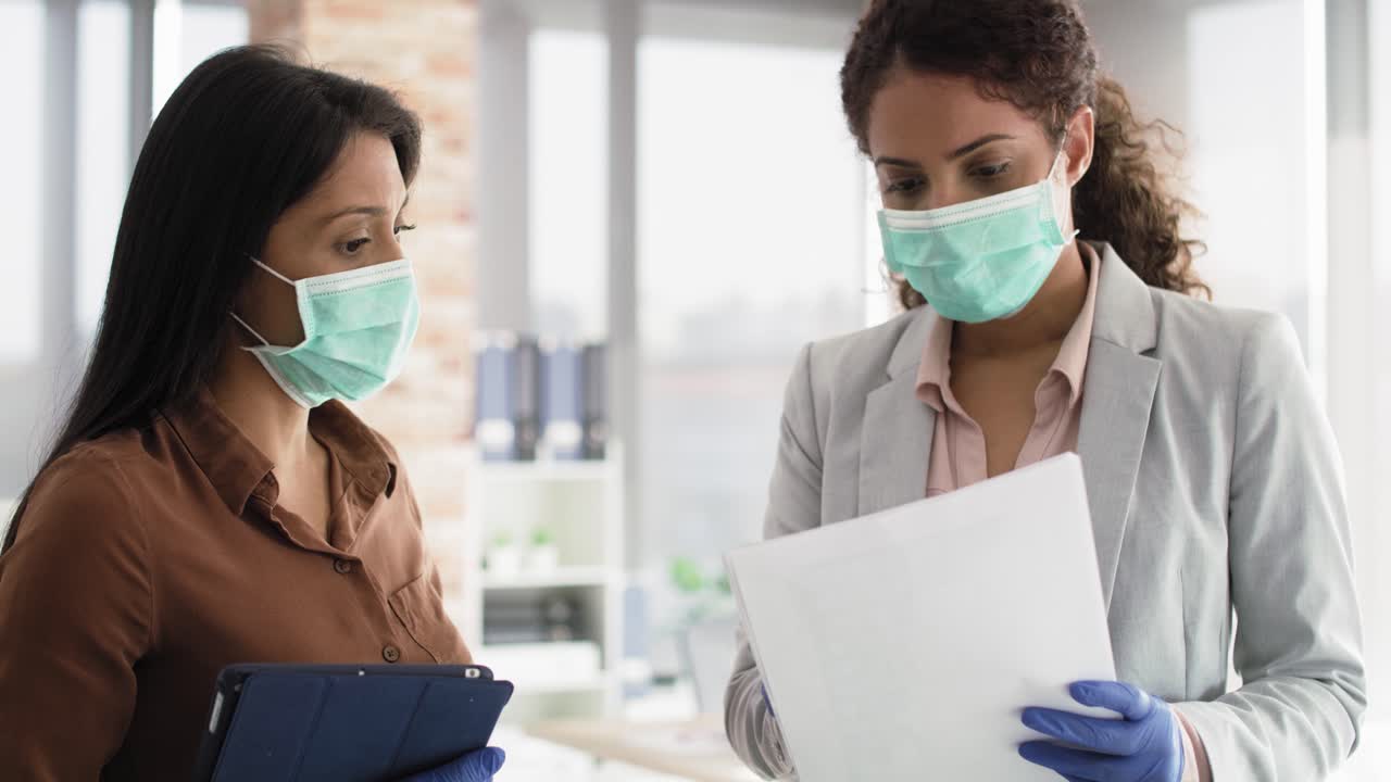 Video of businesswoman reviewing sales figures with coworker
