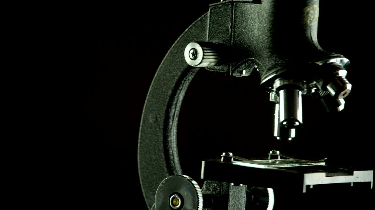Vintage student microscope in seamless looping rotation