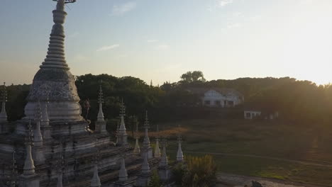 orbiting aerial of old burmese pagoda reveals top is leaning over