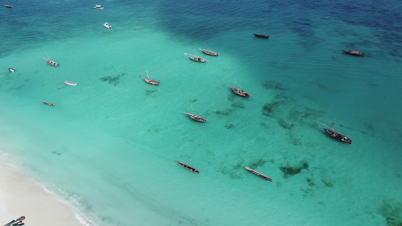 Wooden boats, clear crystal waters at the Indian Ocean (Zanzibar)