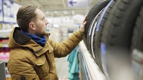 man choosing new tires in shot