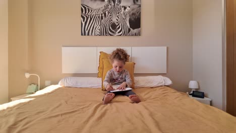 a child sitting on a bed