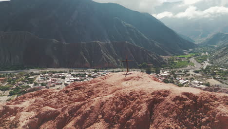 wooden cross on cerro siete colores in the tourist town of purmamarca, jujuy, argentina