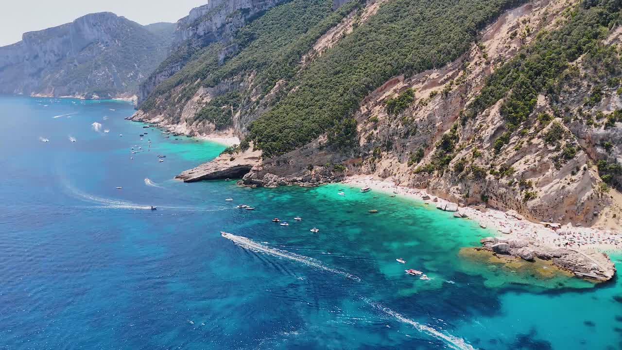 Aerial view of Cala Mariolu beach, Sardinia, with boats and turquoise waters
