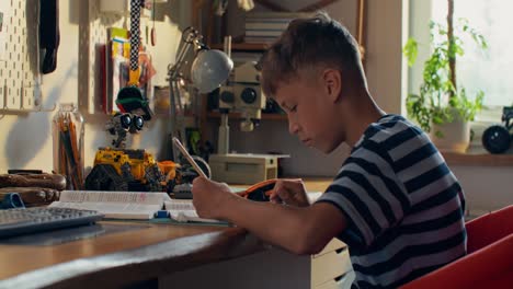 boy studying in his room
