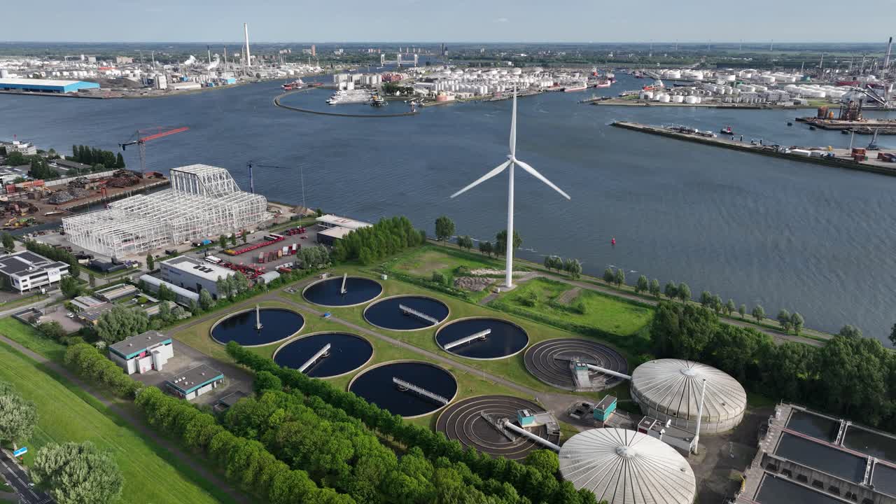 Waste water treatment plant in the port of Rotterdam, along the Meuse river. Cleanign water. Utility in industrial port area. The Netherlands. Aerial view.