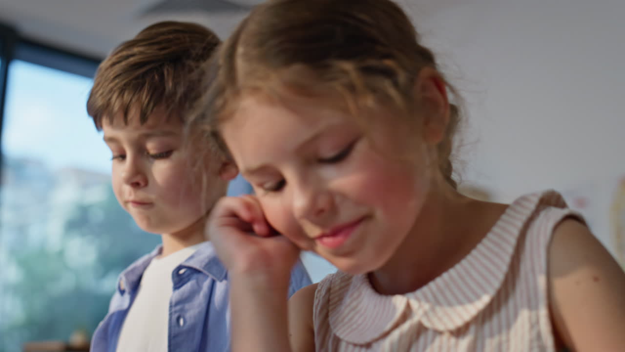 Elementary school classmates working together at lesson closeup. Two students