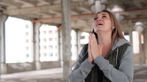 a beautiful woman singing about ukraine in the middle of the ruins of bombed buildings
