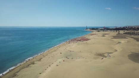 4k aerial footage of a crowded beach (playa des maspalomas) in gran canaria, spain.